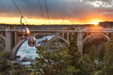 Spokane gondolas crossing the river at sunset